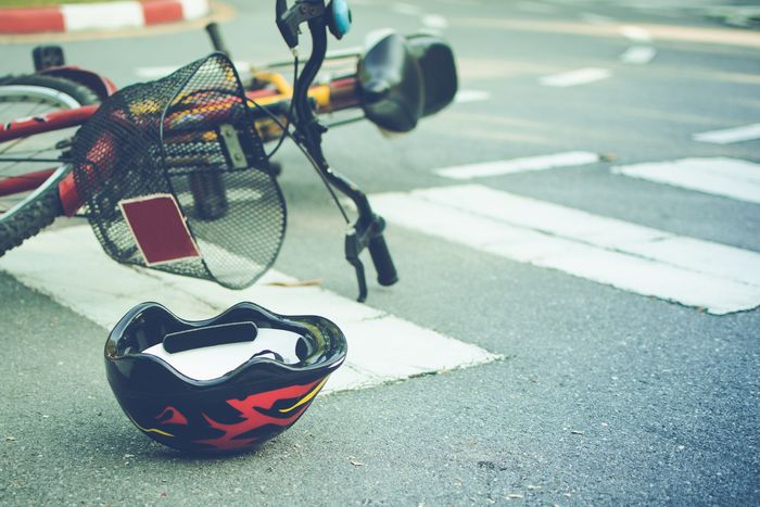 Bicycle and a helmet lying on road Bicycle and a helmet lying on road