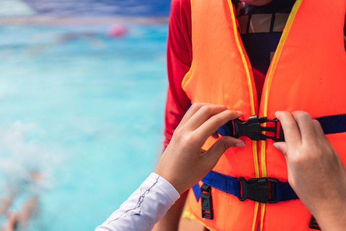 Person putting on life jacket